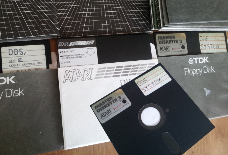 Some Atari 5.25 inch floppies are shown that were used on Atari 800 / 810, 90kb and 1050 Enhanced 130kb disks (sometimes known as 127kb). Most of them are shown inside the paper sleeve except for the bottom right which you can see the megnetic surface through the read slot used by the floppy drive.