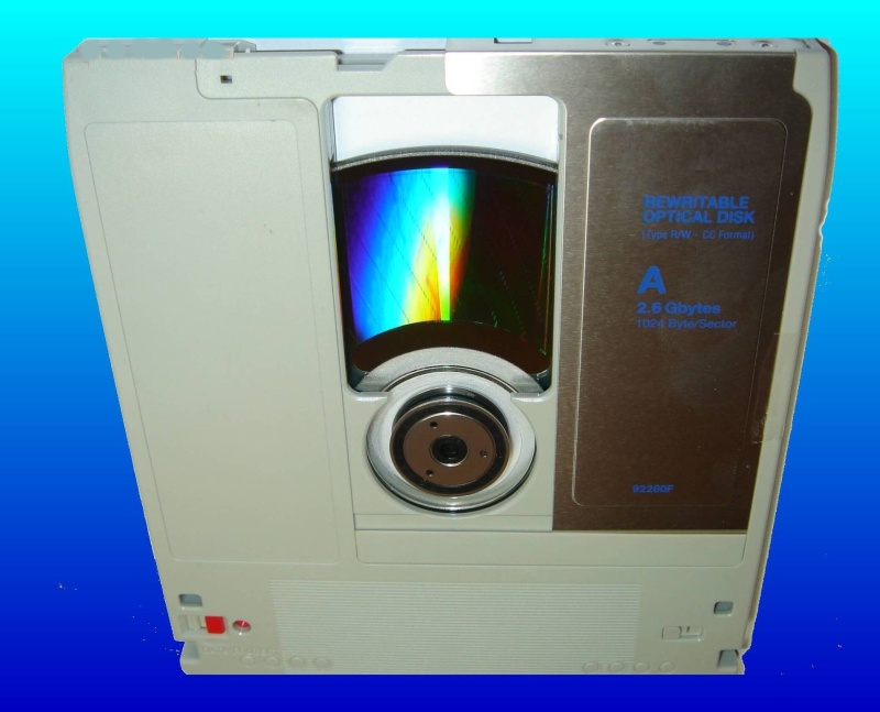 A Magneto Optical Disk that was used to store scanned documents is shown with it's slider cover open and ready for data recovery to DVD.