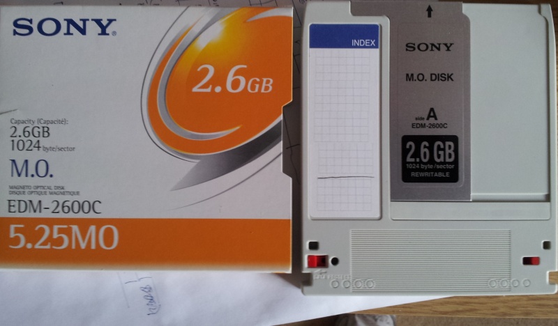 A Sony EDM-2600C MO disk 2.6gb with 1024bytes per sector, that is pictured along with its orange and white cardboard sleeve. The MOD was rewritable and formatted in HP Unix Workstation.