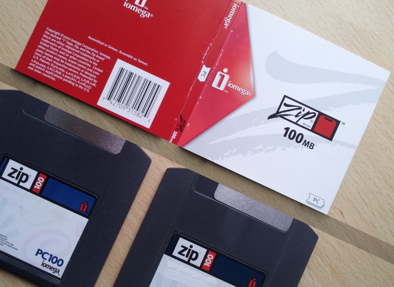 The photo shows 2x Zip 100 discs along with their title sleeve. The disks are made by Iomega and are 100mb capacity. The label indicates they are PC100.