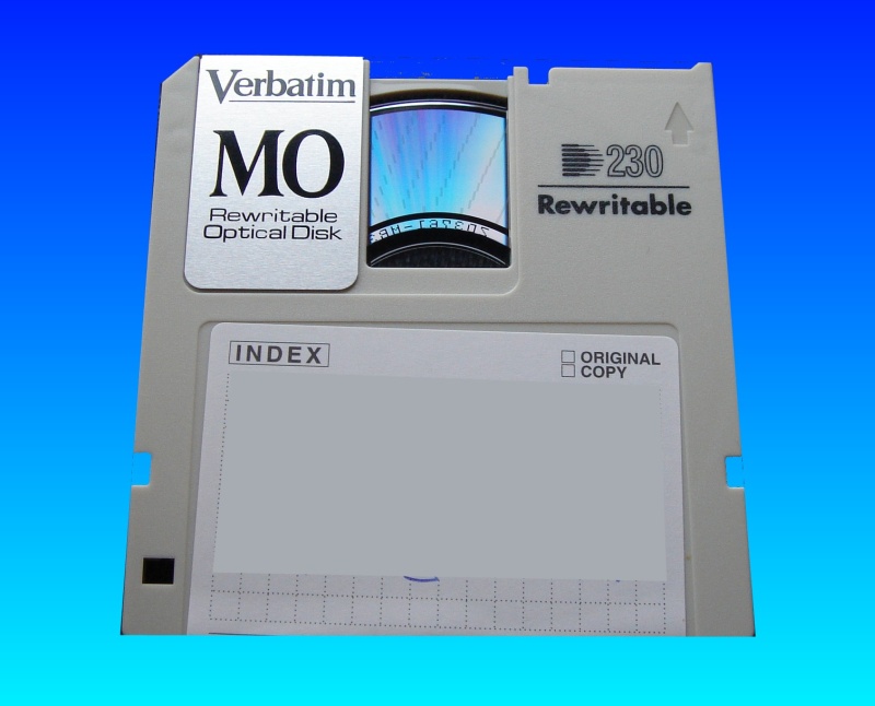 A MO disk by Verbatim ready to have it's files read and transferred to USB. The metal slider cover has been opened to show light diffraction from the disk surface.