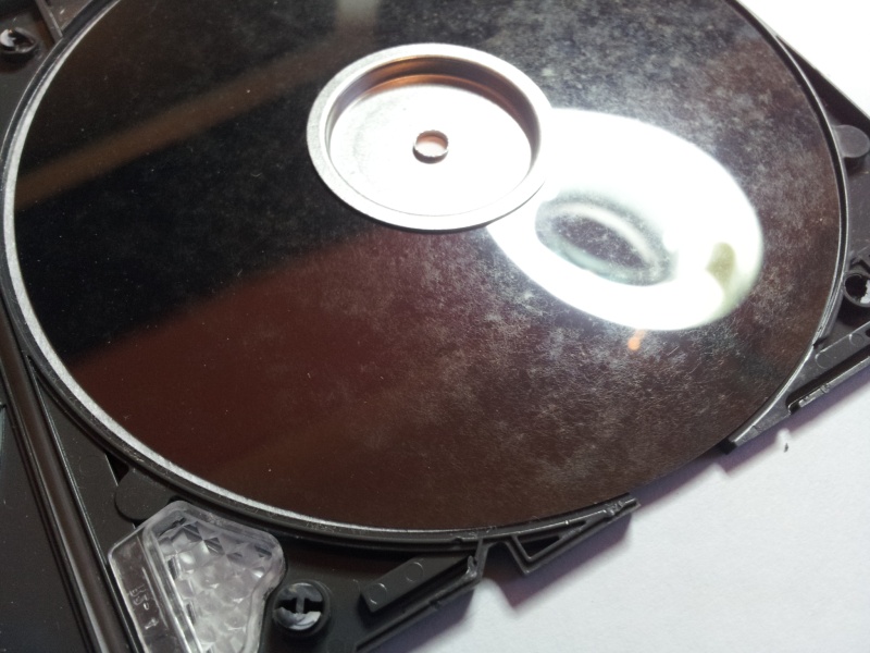 A close up view of the inner disc from a ZIP disk which was sent for recovery. The client had tried to read the data but due to surface contamination over the years had left the disk unreadable.