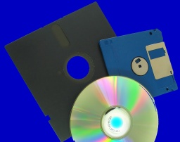 A CD, old 5.25 floppy disk and a modern 3.5 inch flopy disk together.