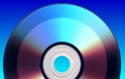 A Double Layer DVD+R turned to face the recording side showing the darker rings where video has already been burnt to the disk.